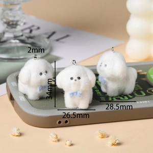 Detailed size view of white flocked dog charms with blue bow for DIY crafts