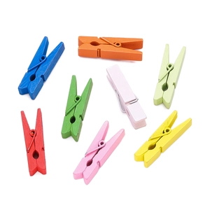 Close-up of vibrant colorful mini wooden clothespins set for photo display and DIY crafts