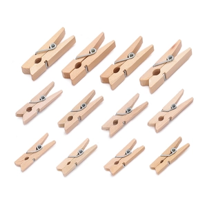 Detailed top view of natural wooden clothespins in three sizes for DIY and photo hanging