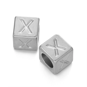 Macro shot of silver stainless steel cube beads with letter X for DIY jewelry making