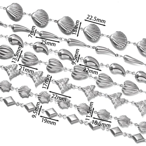 Detailed view of stainless steel chain links with various shell and butterfly charm sizes