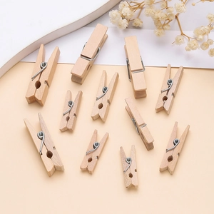 Close-up of natural mini wooden clothespins with metal springs for DIY photo display