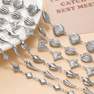 Detailed close-up of silver stainless steel chains with butterfly and shell charms