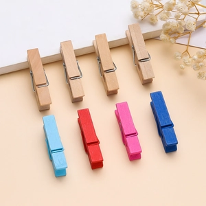 Mini wooden clothespins in mixed colors for photos and DIY crafts on paper