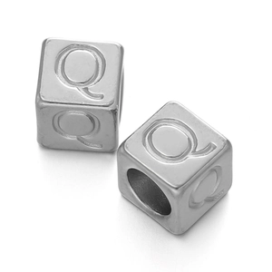 Macro view of 7x7mm stainless steel cube bead with embossed letter Q for DIY jewelry