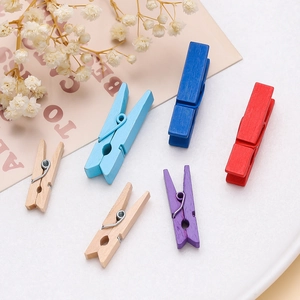 Close-up of colorful wooden mini clips with metal springs for photo wall decor and DIY art
