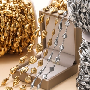 Detailed macro view of mixed stainless steel butterfly and shell charms on golden chains