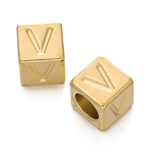Macro shot of 7mm golden stainless steel cube bead with engraved letter V for DIY jewelry