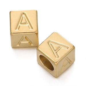 Macro shot of 7mm golden stainless steel cube beads with letter A for DIY jewelry making