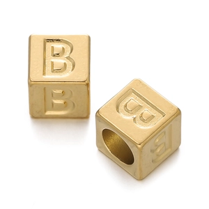 Close-up of golden square letter B charms with holes for DIY jewelry making and necklaces