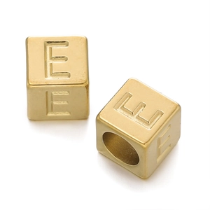 Macro shot of 7mm golden stainless steel cube beads with letter E for DIY jewelry