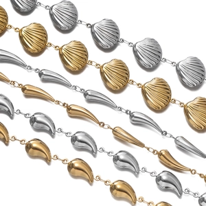 Detail of stainless steel chains with seashell and teardrop charms for jewelry making