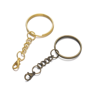 Detail of flat metal key rings with lobster clasps in gold and bronze finishes