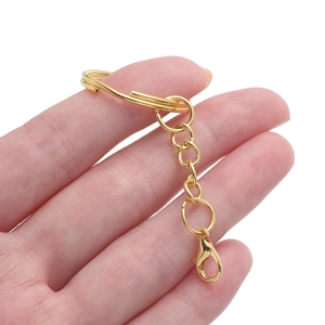 Close-up of golden flat split ring keychain with lobster clasp and chain for DIY crafting
