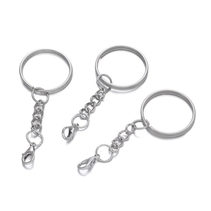 Detail of three silver metal keychains with large rings, short chains and lobster clasps