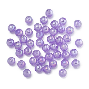 Macro shot of iridescent purple AB acrylic beads with a hole for DIY jewelry making
