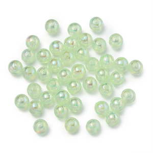 Macro detail of translucent light green AB coated round beads with central threading holes