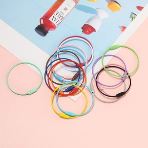 Colorful steel wire keychains with threaded locks displayed on a light pink background