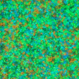 Macro shot of mixed luminous gravel in green, yellow, and blue for DIY landscaping