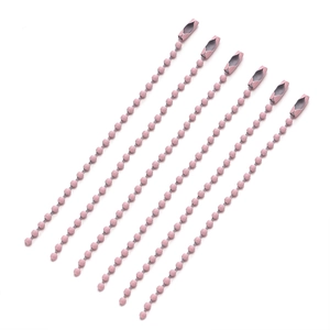 Detailed view of pink metal ball chain keychains with connector clasps on white background