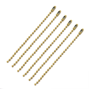 Macro view of seven yellow metal ball chains with golden connectors for DIY crafts