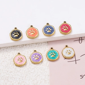 Detail view of eight colorful enamel paw print charms in gold-plated stainless steel