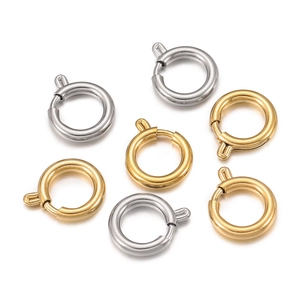 Detailed macro view of gold and silver polished spring ring clasps for jewelry making