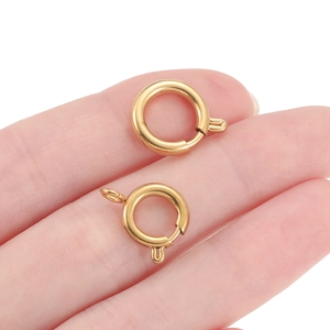 Two gold-plated stainless steel spring ring clasps for DIY jewelry making held by fingers