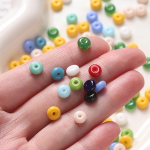 Close-up of 3x6.5mm colorful glass abacus beads held in hand for DIY jewelry making
