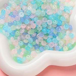 Macro shot of macaron colored glass abacus beads in a white floral tray for DIY projects