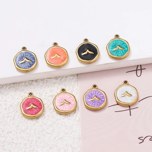 Detail of round gold-plated enamel pendants with bird motif in eight vibrant colors