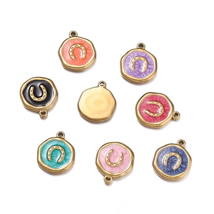 Detail of colorful enamel horseshoe charms in gold plating for DIY jewelry making