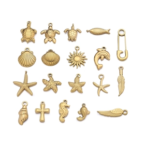 Flat lay of 19 gold-plated stainless steel ocean series charms for DIY jewelry