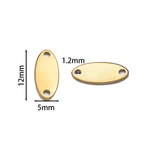 Macro view of oval gold stainless steel dog tags with dual 1.2mm holes and 12mm length