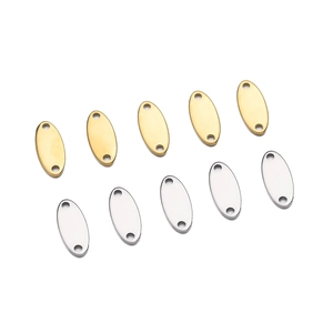 Detailed view of oval stainless steel double-hole DIY jewelry tags in gold and silver