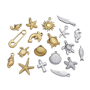 Mix of gold and silver sea-themed pendants including turtles, starfish and shells