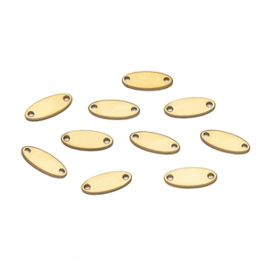 Macro view of gold-tone oval stainless steel pendants with double holes for DIY jewelry
