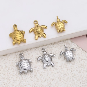 Detail of sea turtle pendants in gold and silver finish with varied shell textures