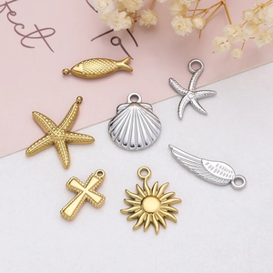 Close-up of assorted stainless steel ocean charms in gold and silver for DIY jewelry