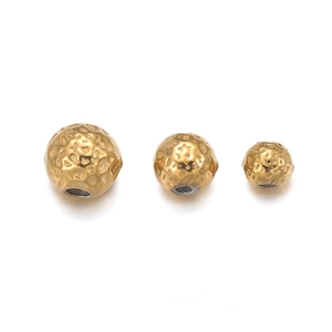 Detailed view of three 18k gold plated stainless steel hammered texture spacer beads
