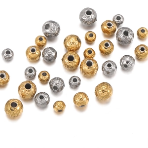Detailed macro view of 18k gold and silver plated textured metal beads for jewelry making