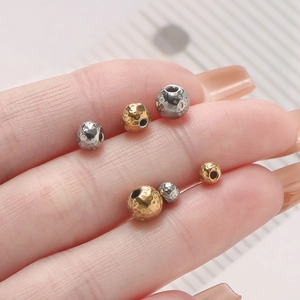 Macro shot of 18k gold and silver plated hammered metal beads for DIY jewelry making