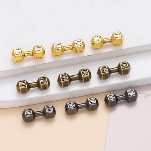 Macro detail of alloy dumbbell spacer beads with Live Lift engraving in three metal finishes