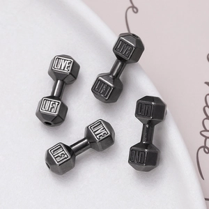 Close-up of metal dumbbell beads with LIVE LIFT engraving for jewelry making