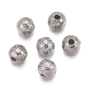Detail of six 18k gold plated stainless steel textured spacer beads for DIY jewelry