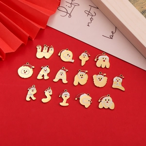 Detail of 18k gold plated Christmas alphabet pendants with red and white enamel finish