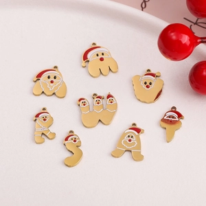 Macro detail of 18k gold plated Christmas letter charms with red and white enamel art