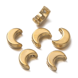 Macro view of polished gold crescent moon beads for DIY jewelry making with side holes