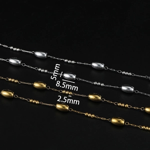 Detailed view of gold and silver stainless steel chains with 8.5mm oval and 2.5mm round beads