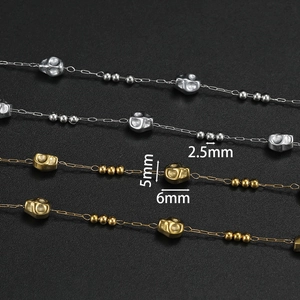 Macro detail of skull and bead chain links with measurements in gold and silver finish